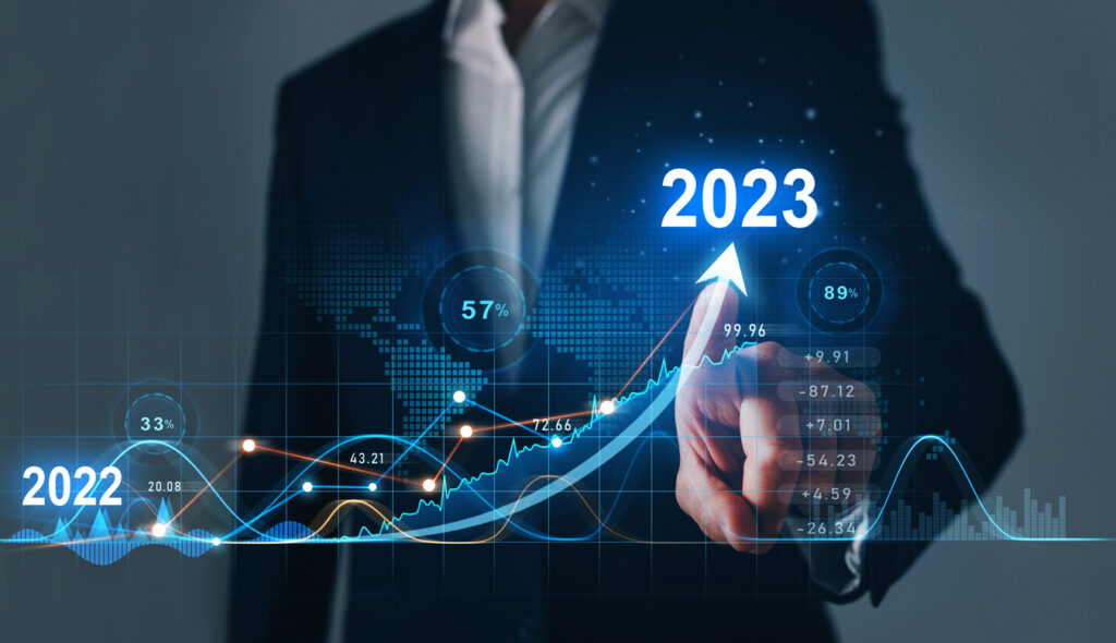 A businessman is pointing at a graph with the word 2020.