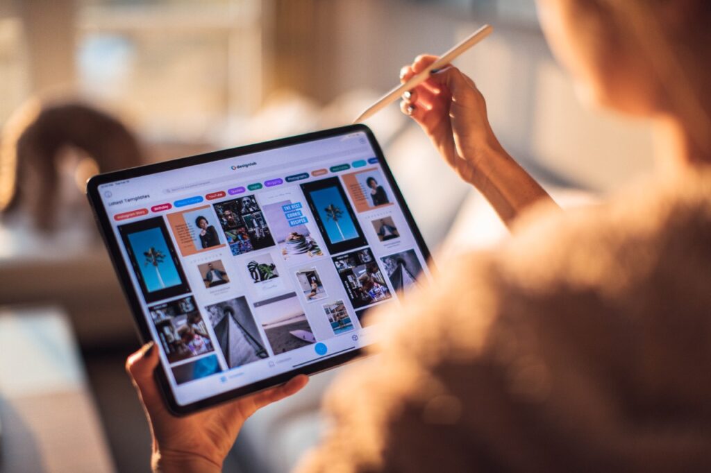 A woman is holding an iPad showcasing visual marketing analysis.