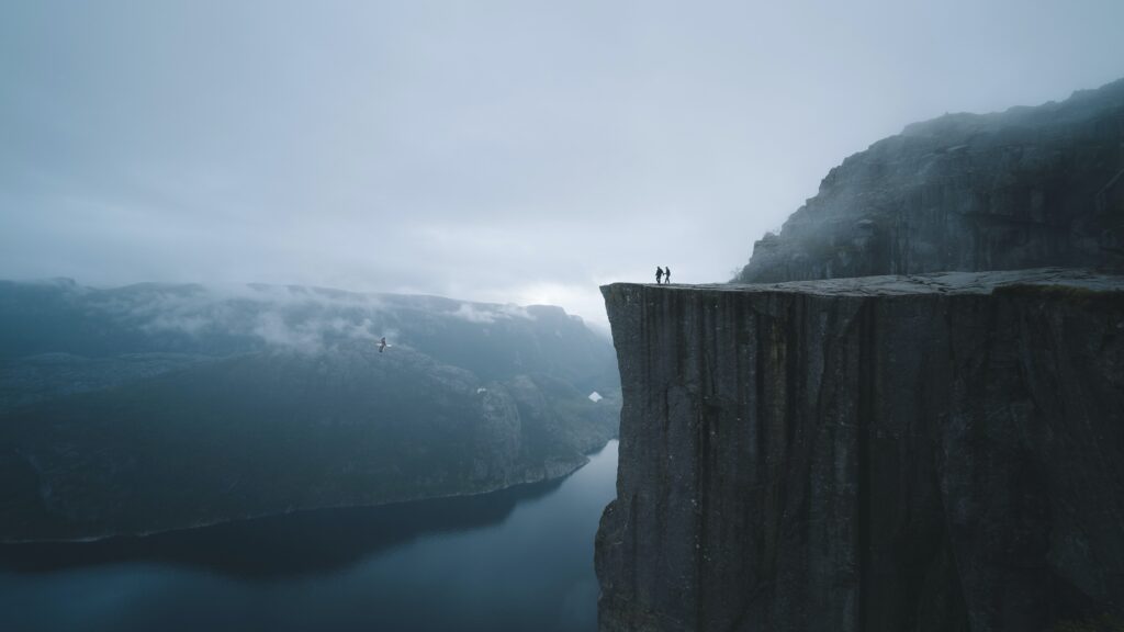 Two people mastering a cliff.