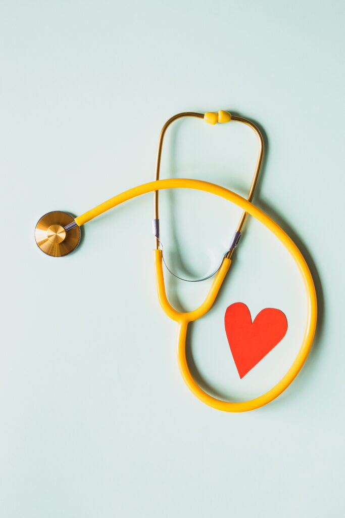 A stethoscope with a red heart on a blue background.