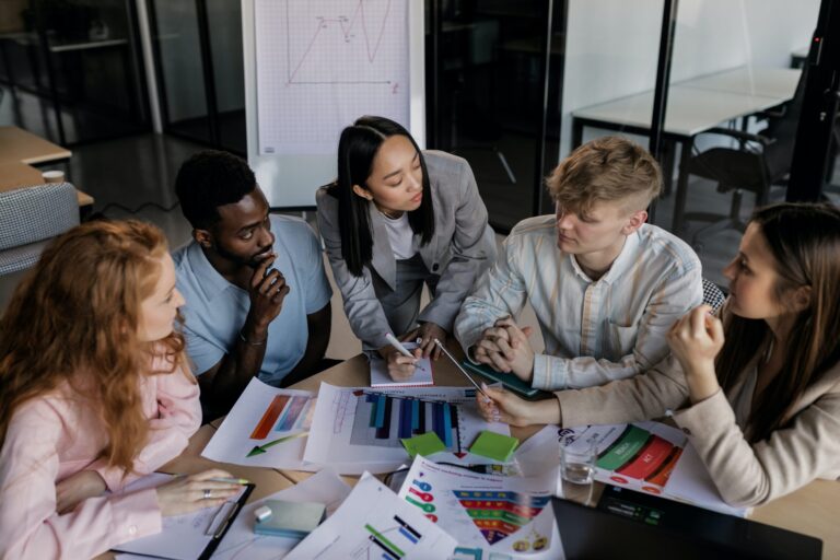 An office group analyzing marketing ROI with analytics for digital campaigns.